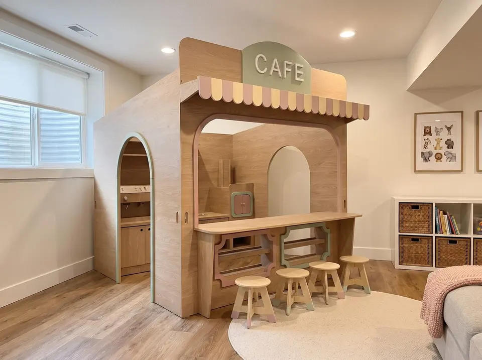 Custom wooden indoor cafe playhouse with awning and bar stools in playroom