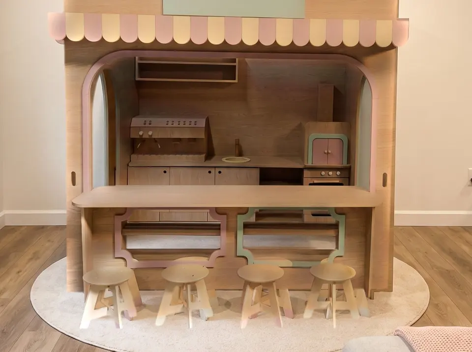 Front counter and stools of wooden indoor cafe playhouse