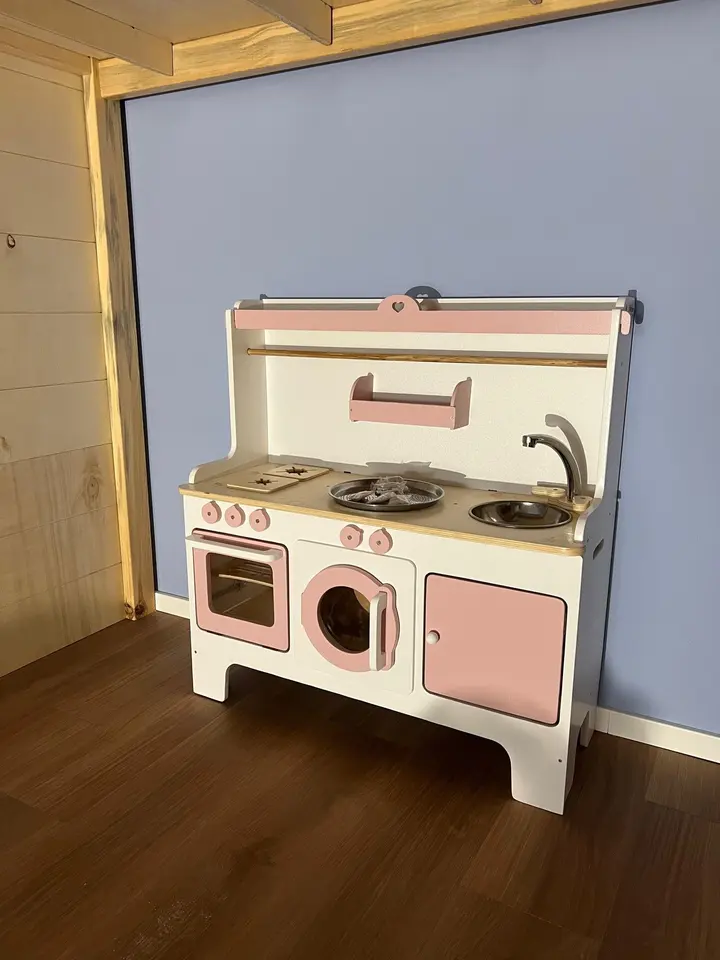 White and pink wooden play kitchen with washing machine and sink