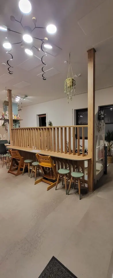 Wooden slat room divider with counter seating and children high chairs