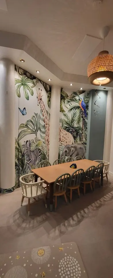Kids activity dining table and chairs against safari animal wallpaper
