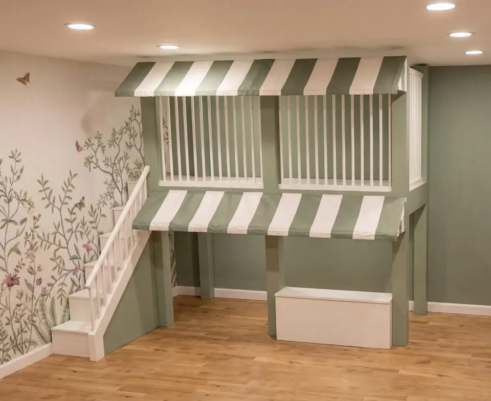Two story indoor play structure with striped awnings beside floral wallpaper