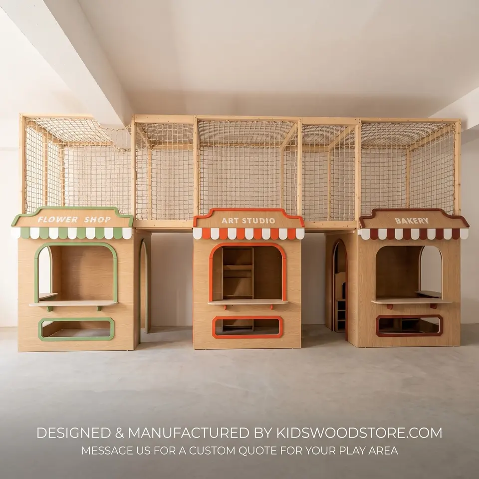Front view of wooden play village kiosks under an upper mesh bridge area