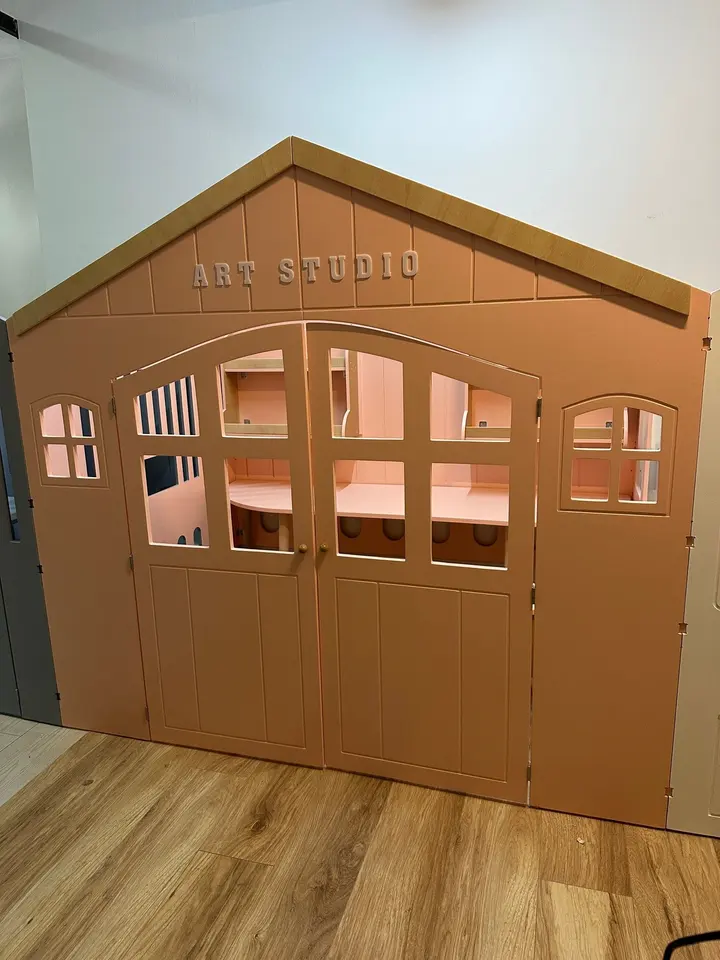 Pink wooden art studio playhouse facade with double doors and windows