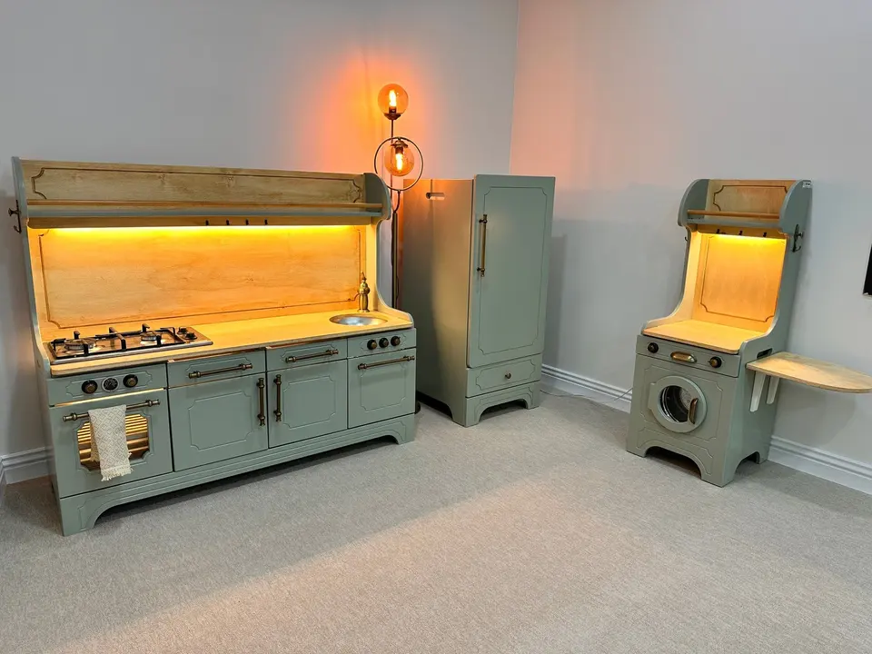 Vintage-style wooden play kitchen, refrigerator, and washer playset in sage green
