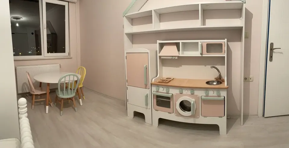 Play kitchen and miniature dining set inside a child bedroom