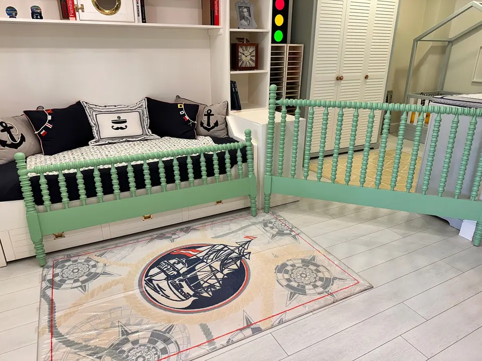Light green turned wood daybed frames in a nautical themed children room