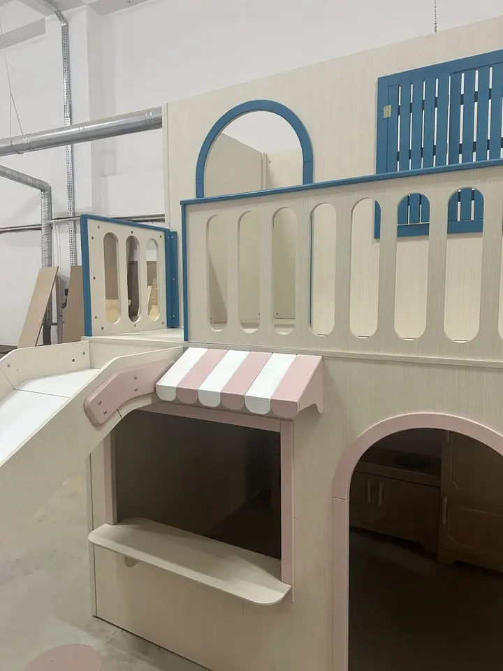 Detail of wooden playhouse with striped awning, arched door, and balcony