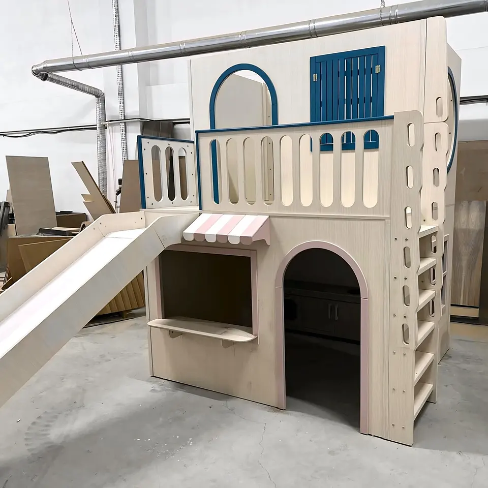 Assembled two-story playhouse bed with slide and balcony on factory floor