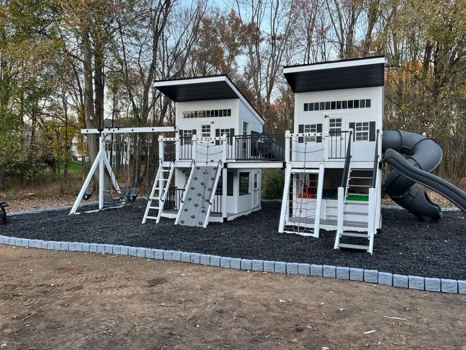 Modern black and white dual tower outdoor playhouse with swings and slide