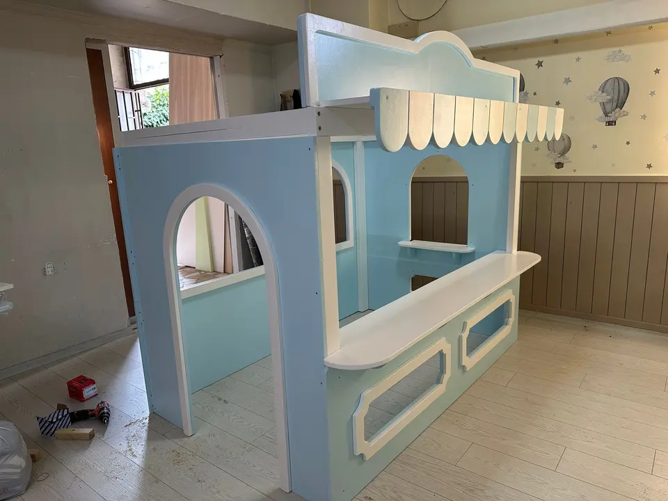 Light blue wooden play market stall with striped awning and arched entrance