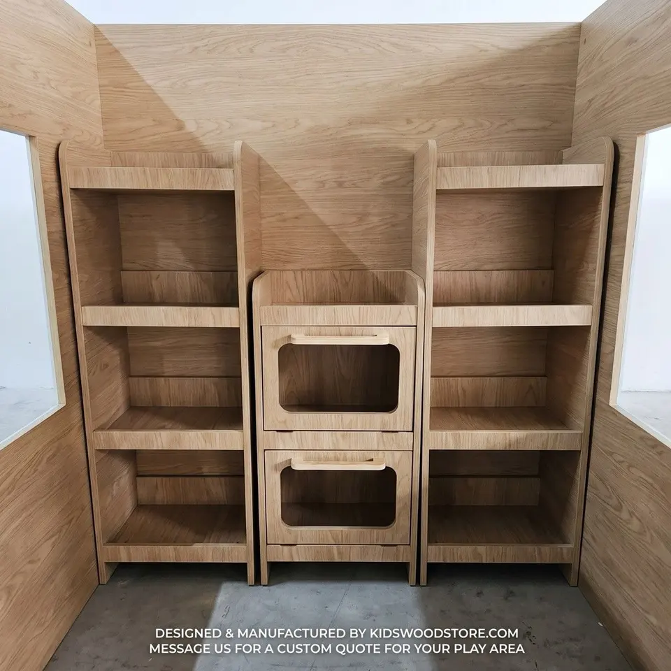 Oak playhouse interior fitted with wooden display shelves and drawer unit