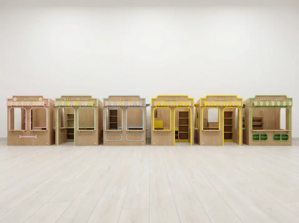 Row of miniature wooden play store kiosks lined against white wall