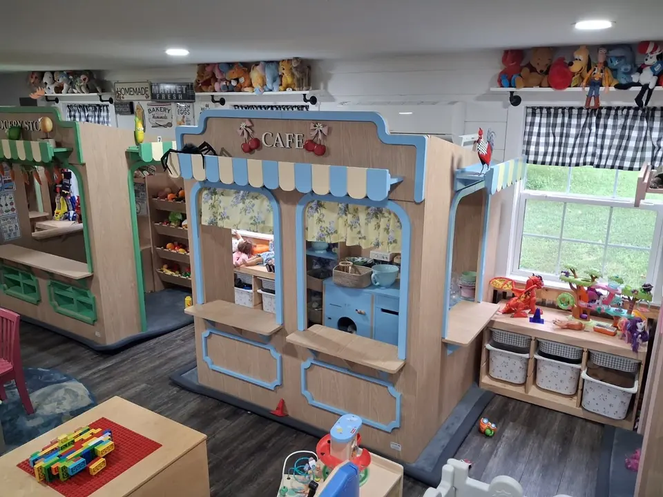 Wooden play cafe booth installed in a children playroom