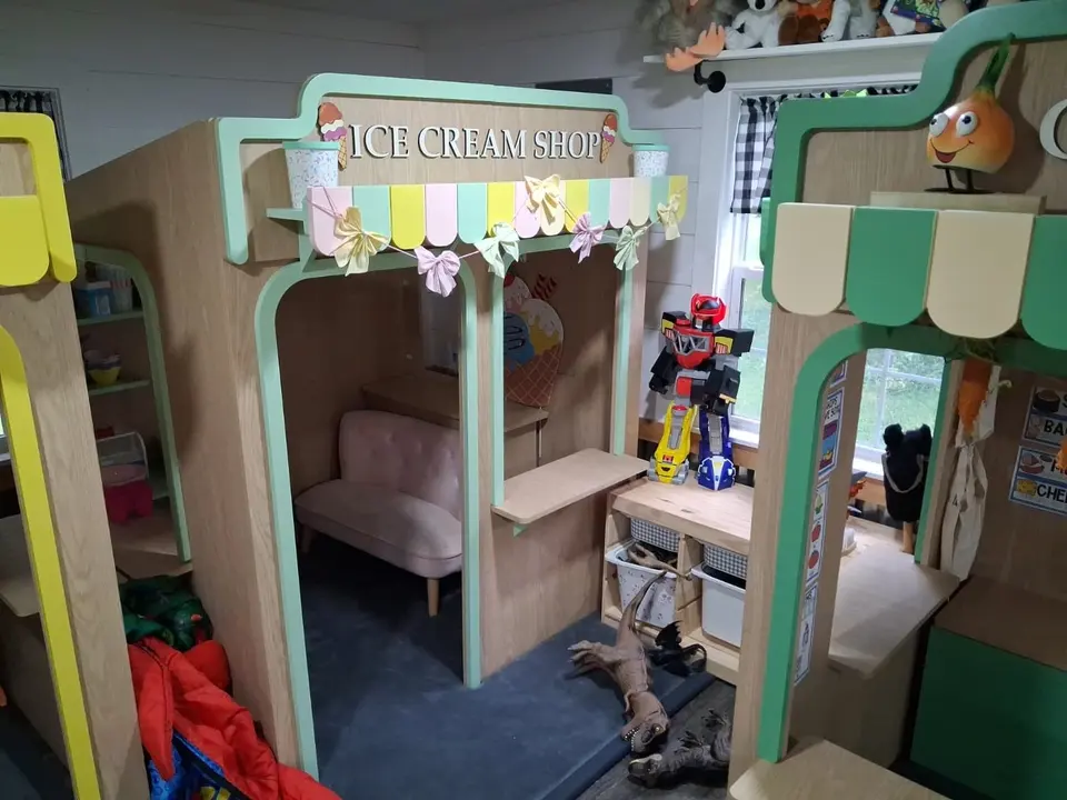 Indoor wooden ice cream shop playhouse with bench and service counter
