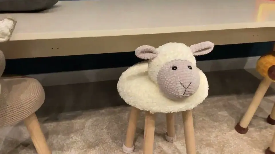 Wooden child stool with plush sheep head and fluffy white seat cover