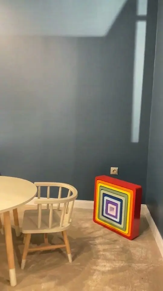 Small round table and wooden chair in a corner of a playroom