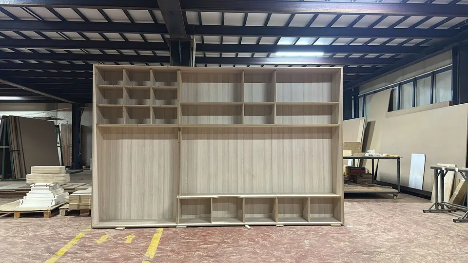 Large wooden shelving unit and cubby storage built in a workshop