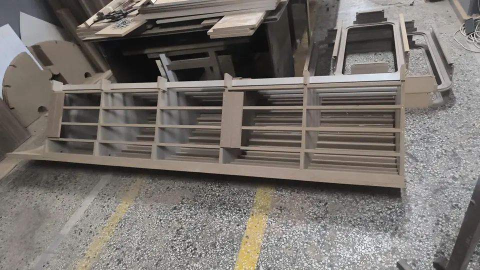 Unfinished wooden shelving unit lying on workshop floor