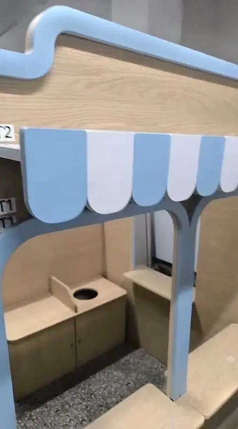 Playhouse counter and striped awning under assembly in workshop