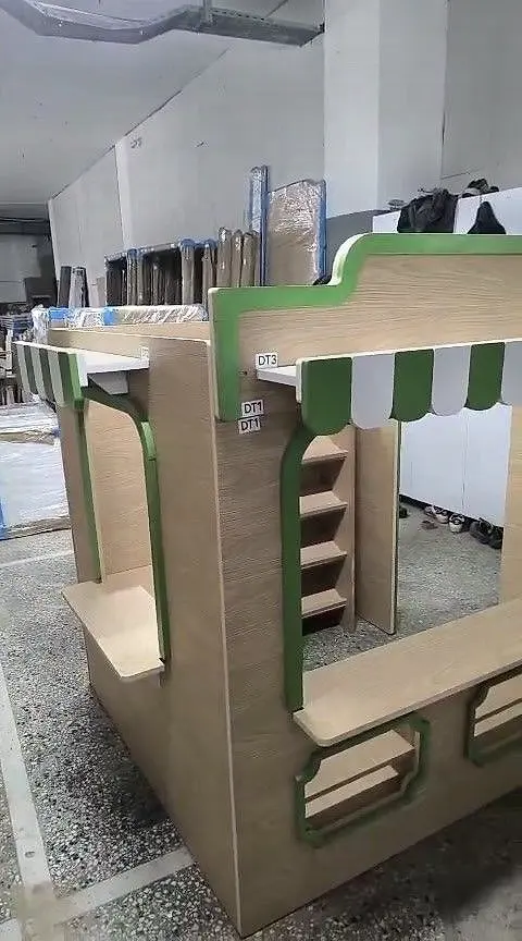 Wooden play shop stall with green awning assembled in workshop