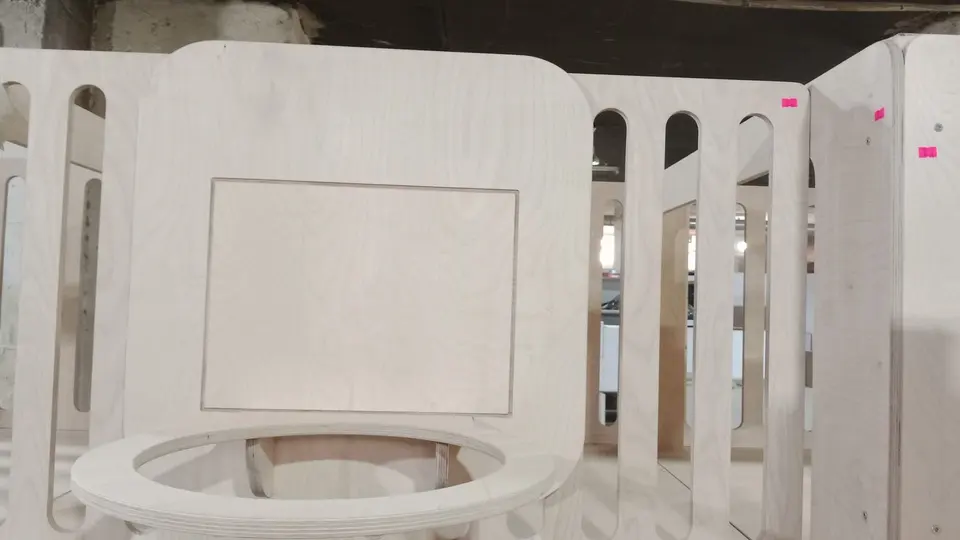 Wooden playhouse railing and attached basketball hoop in a workshop