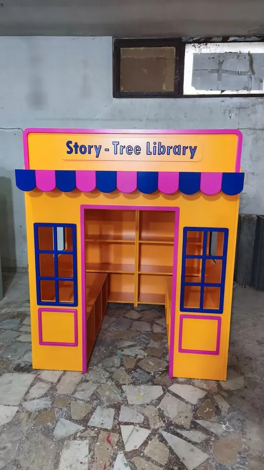 Yellow wooden story tree library playhouse booth in a workshop