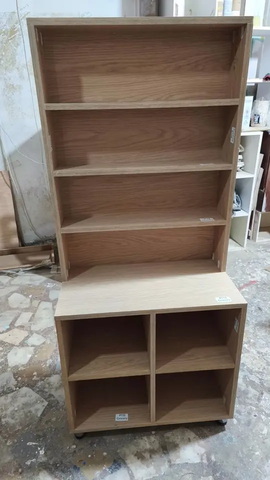 Light wood shelving and cubby storage unit on wheels in a workshop