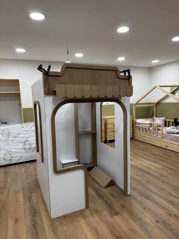 Wooden kiosk playhouse assembled in a furniture showroom display area
