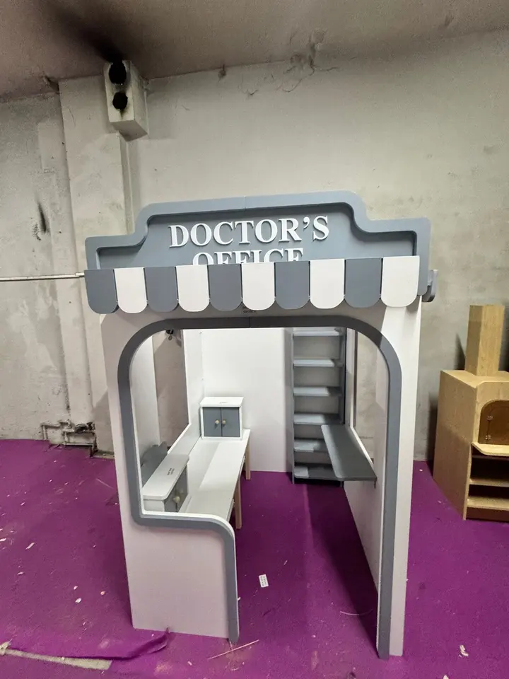 Front view of grey and white doctors office playhouse stall