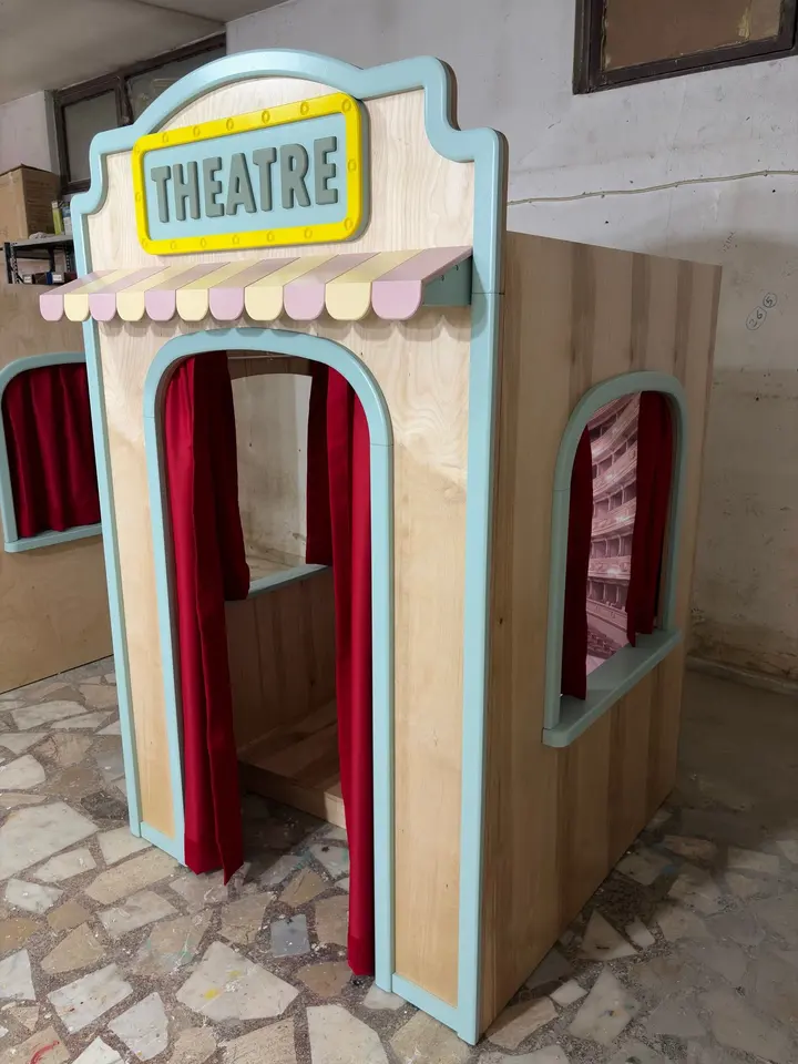 Side perspective of wooden theatre playhouse booth with red curtains